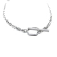 Load image into Gallery viewer, Close up of sterling silver toggle clasp, featuring an asymmetric, hexagon link attached to right-side of square link chain and a long rectangular bar attached to left-side of square link chain. The bar is threaded through the hexagon and shows a closed toggle clasp. 
