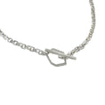 Load image into Gallery viewer, Close up of sterling silver toggle clasp, featuring an asymmetric, hexagon attached to right-side of square link chain and a rectangular bar attached to left-side of square link chain. The bar is threaded through the hexagon and shows a closed toggle clasp.
