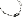 Load image into Gallery viewer, Sterling silver necklace with a unique puzzle clasp design featuring a geometric, rectangular charm with an open section and a grid-like pattern. The necklace consists of an assortment of interconnected rectangular and square chain links, giving it an intricate and modern look.
