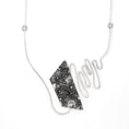 Load image into Gallery viewer, A modernist inspired handmade sterling silver necklace showcasing an undulating bar on the left side, mimicking soundwaves, culminating at the left side of an asymmetric pentagon hollowform. The hollowform has a blackened, heavily textured surface, evoking a brutalist sensibility. Emerging from the bottom of the hollowform, the silver bar creates the illusion of continuity as it curves upward, connecting to a bar and link chain.
