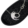 Load image into Gallery viewer, Modern silver asymmetric pendant featuring a medium circle surrounded by 7 concentric circles in a black dish with black stones 
