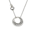 Load image into Gallery viewer, Contemporary sterling silver necklace with a prominent outer circle surrounded by five descending, staggered inner circles. The inner circles showcase varying textures, some chisel-textured and blackened for enhanced visual contrast. Suspended from a sterling silver cable chain, the pendant is complemented by four irregularly sized and textured rings positioned 1.5 inches up the chain on the right side 
